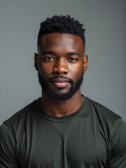 A portrait of a man with short hair and a beard, wearing simple attire. His confident expression and composed demeanor convey a sense of self-assurance and strength.