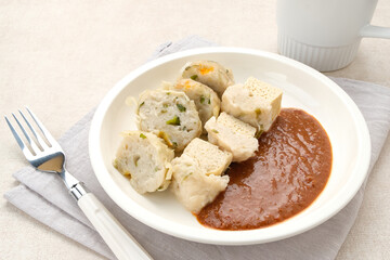 Siomay Bandung (Shumay) or steamed dumplings with boiled tofu. Indonesian traditional street food with peanut sauce.
