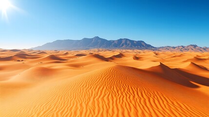 A vast desert landscape features golden sand dunes under a clear sky and bright sunlight, with crisp shadows and a distant mountain range highlighted in vivid detail.