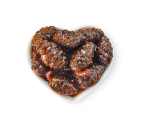 Pine cone jam in ceramic bowl isolated on white background top view. Natural product for health and immunity.   