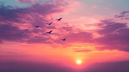 A serene sunset with silhouettes of birds flying across a vibrant sky, creating a tranquil and picturesque landscape. 