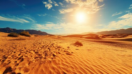 A barren desert landscape, with sand dunes and no vegetation in sight, under the blazing dry season sun.