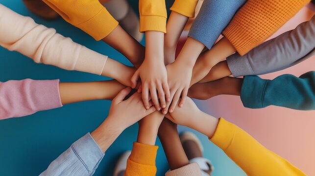 Diverse hands coming together in unity and teamwork. Symbol of collaboration and support.