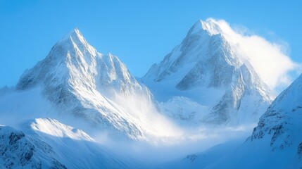 Snow-covered mountain peaks under a clear blue sky, with fresh powder waiting to be explored.