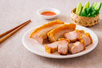 Crispy pork belly on white plate and dipping sauce