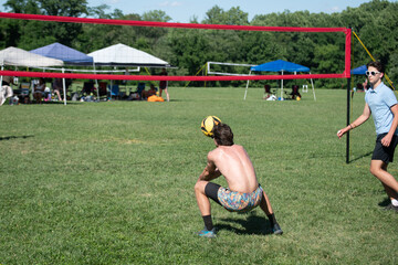 Male volleyball players playing grass doubles