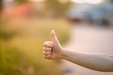 a man's thumb is raised upwards. The hand gesture shows as if you are praising something.