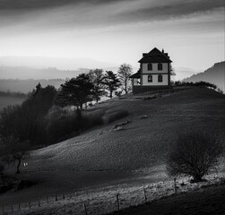 At dusk amidst the landscape and trees, you can enjoy the full view of a lonely romantic place. In black and white