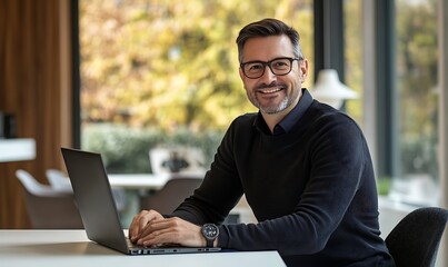 Entrepreneur Working on Laptop by Window