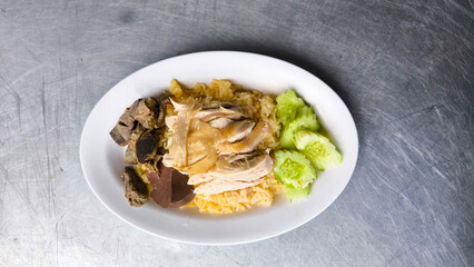 Chicken rice in a white plate on the dining table