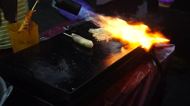 grilling sausages and enoki mushrooms