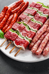 raw sausage meat assorted juicy pork, beef fresh gourmet food background on the table rustick food top view copy space