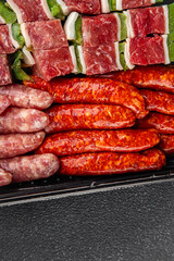 raw sausage meat assorted juicy pork, beef fresh gourmet food background on the table rustick food top view copy space