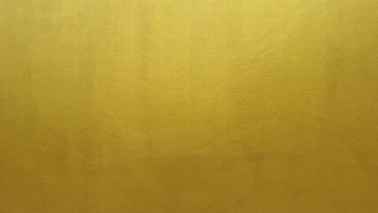 Golden concrete wall background texture. Gold classic texture. Wall for the background. Yellow or gold wallpaper backdrop.