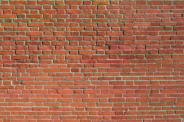 Fototapeta premium Red brick wall background. Old brickwork texture. Rock block pattern. Vintage stonewall. Abstract grunge urban design. Building masonry backdrop.