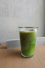 close up of iced matcha green tea latte in a glass