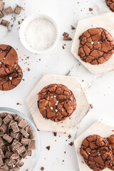 Close-up of brownie cookie with salt flakes on a wooden coaster