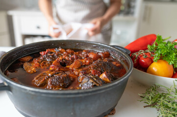 Homemade food with fresh braised beef shank slices in a pot on kitchen counter