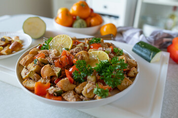 Healthy tuna salad with roasted cubed bread and vegetables on kitchen counter