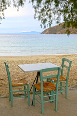 Table with chairs on Aegiali beach. Amorgos island. Cyclades, Greece