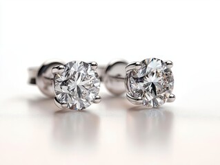 A pair of diamond solitaire earrings isolated on a white background, with each gemstone sparkling brightly solitaire earrings, gemstone, clarity