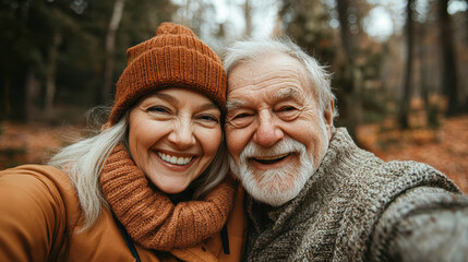 Fototapeta premium Joyful Elderly Couple Taking a Selfie on a Sunny Walk Active Lifestyle and Happiness Concept