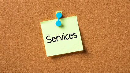 Services word written on a note sticky on corkboard