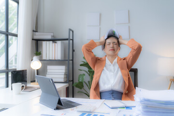 Obraz premium Sad Tired Asian woman Overworked On Computer.Unhappy Frustrated Business Woman, Business Finance Deadline.Sad Tired Businesswoman In Office.Annoyed Overwhelmed Exhausted Stressed