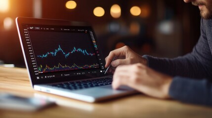 A person analyzing stock market trends on a laptop, featuring a digital trading chart, in a modern workspace setting.