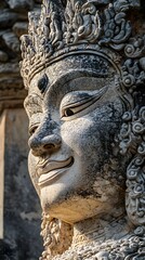 Obraz premium Closeup Photograph of an Intricately Carved Stone Deity Statue with Highly Detailed Facial Features,Textural Patterns,and Ornamental Architectural Design Elements.