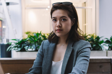 Asian female browsing laptop at cafe