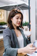 Upset remote worker browsing on smartphone