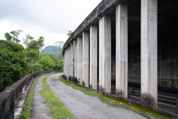Fototapeta premium Exterior view of a tunnel with concrete pillars for support.