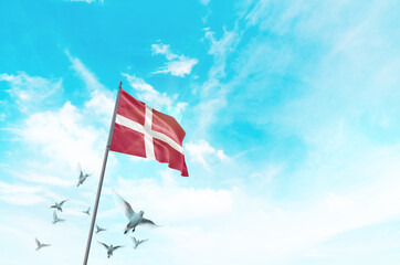 Denmark flag waving with flying doves in beautiful sky. Denmark flag for Republic Day and...