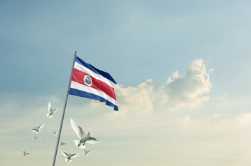 Costa Rica flag waving with flying doves in beautiful sky. Costa Rica flag for Republic Day and...