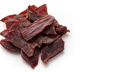 dry savory Peppered Beef Jerky view from above isolated on white background with copy space. lean trimmed meat cut into strips and dehydrated with salt added to prevent spoilage and bacteria growth