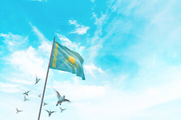 Kazakhstan flag waving with flying doves in beautiful sky. Kazakhstan flag for Republic Day and...