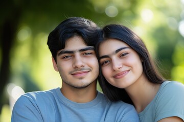 Fototapeta premium A close-up portrait of a young Indian or Pakistani couple wearing casual t-shirts, with a blurred background.