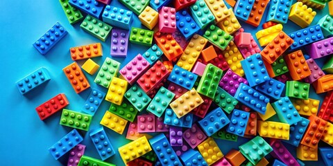 Fototapeta premium Colorful rainbow toy bricks scattered in a vibrant background