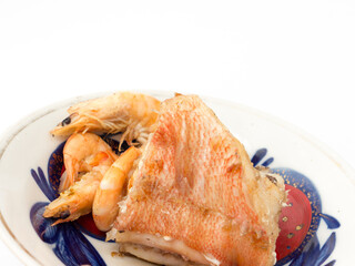 Boiled shrimp and fish on a plate.