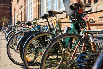 Obraz premium Many bicycles parked at a public bike rack in Copenhagen. Bike parking in Copenhagen. Concept of sustainable transportation and modern urban living in Denmark