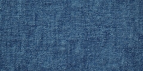 Naklejka premium Blue denim fabric texture with diagonal weaving patterns and soft lighting, creating a classic and rugged look, ideal for fashion, textile design, or background concepts for creative projects 