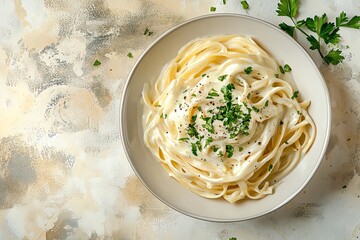 Creamy fettuccine pasta topped with fresh herbs, a delightful dish perfect for any meal or special occasion.