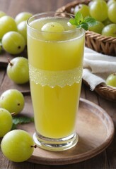 Fototapeta premium green grape juice with a slice of lemon and mint leaves in a tall glass
