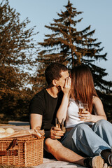 Young couple having a picnic in the park.