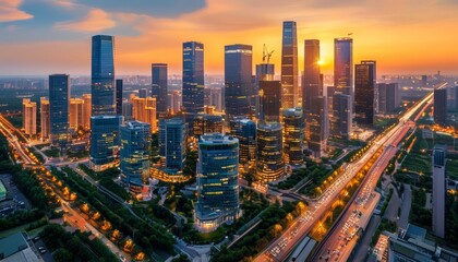 Obraz premium Aerial view of modern city skyline at sunset