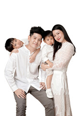 Happy Asian family portrait with parents and two children in white clothing, smiling and enjoying...