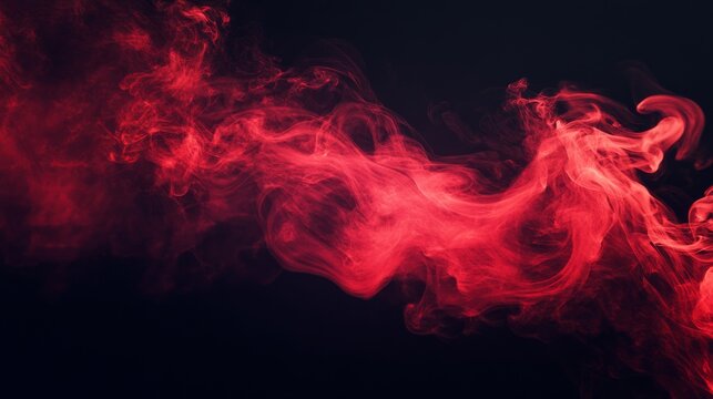 Red smoke forming abstract shapes on black background