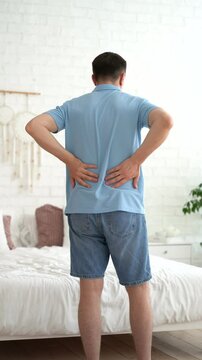 Back pain, kidney inflammation, man suffering from backache at home, health problems concept