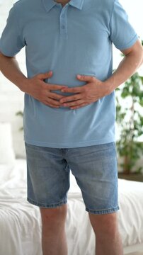 Stomach ulcer, man with abdominal pain suffering at home, symptoms of gastritis, diseases of the digestive system, health problems concept